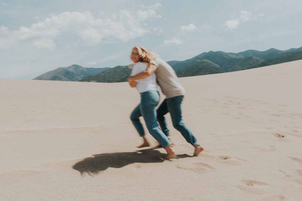 couple posing for photos in a sandy area in Colorado