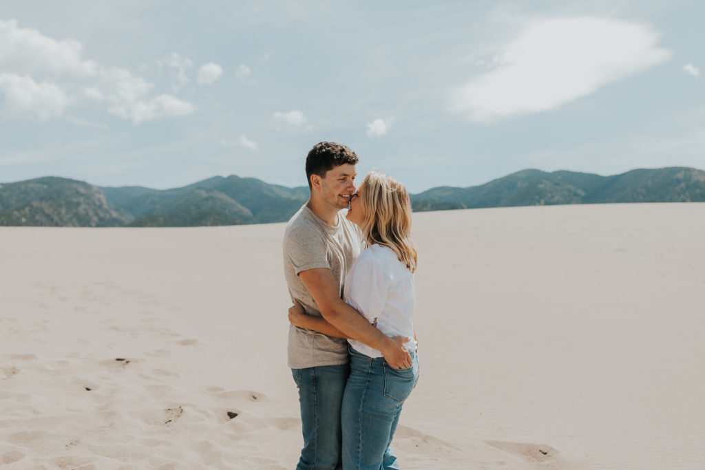 couple posing for photos in a sandy area in Colorado