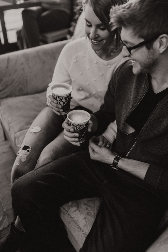 engaged couple drinking coffee in a coffee shop