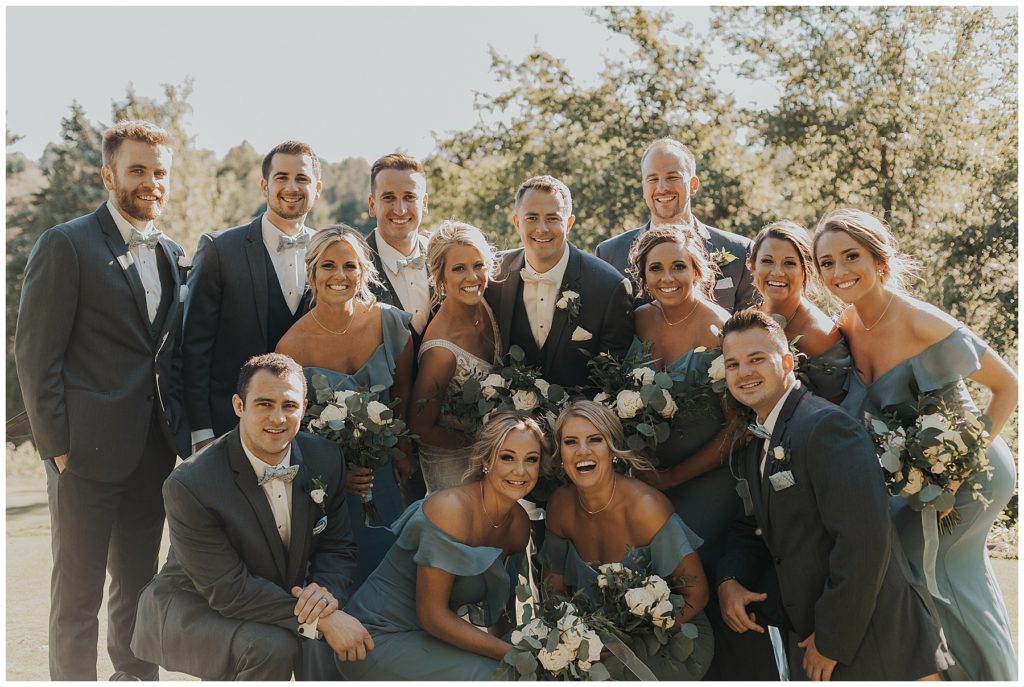 bride and groom with their bridal party on wedding day