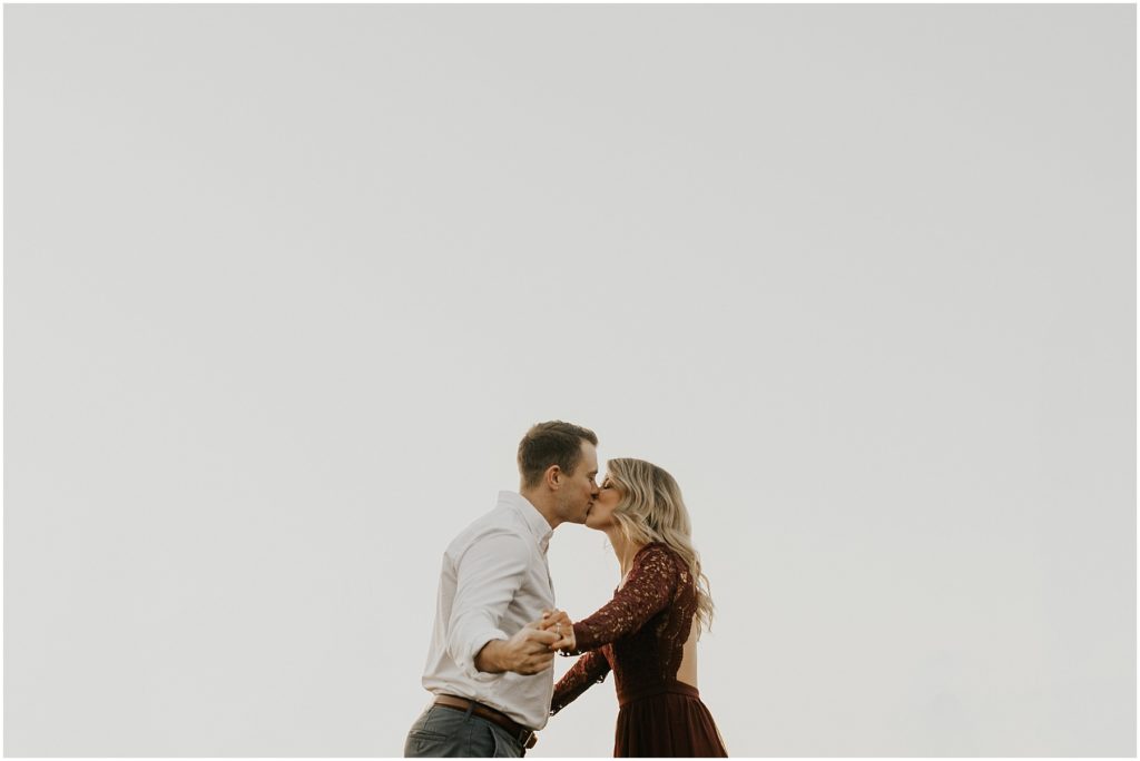 fall engagement session, engaged couple in a meadow holding hands