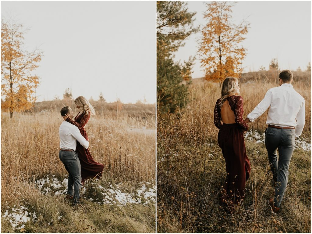 fall engagement session, engaged couple in a meadow holding hands