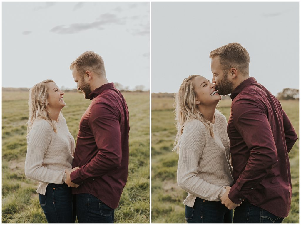 couple taking portraits and kissing in a field during golden hour