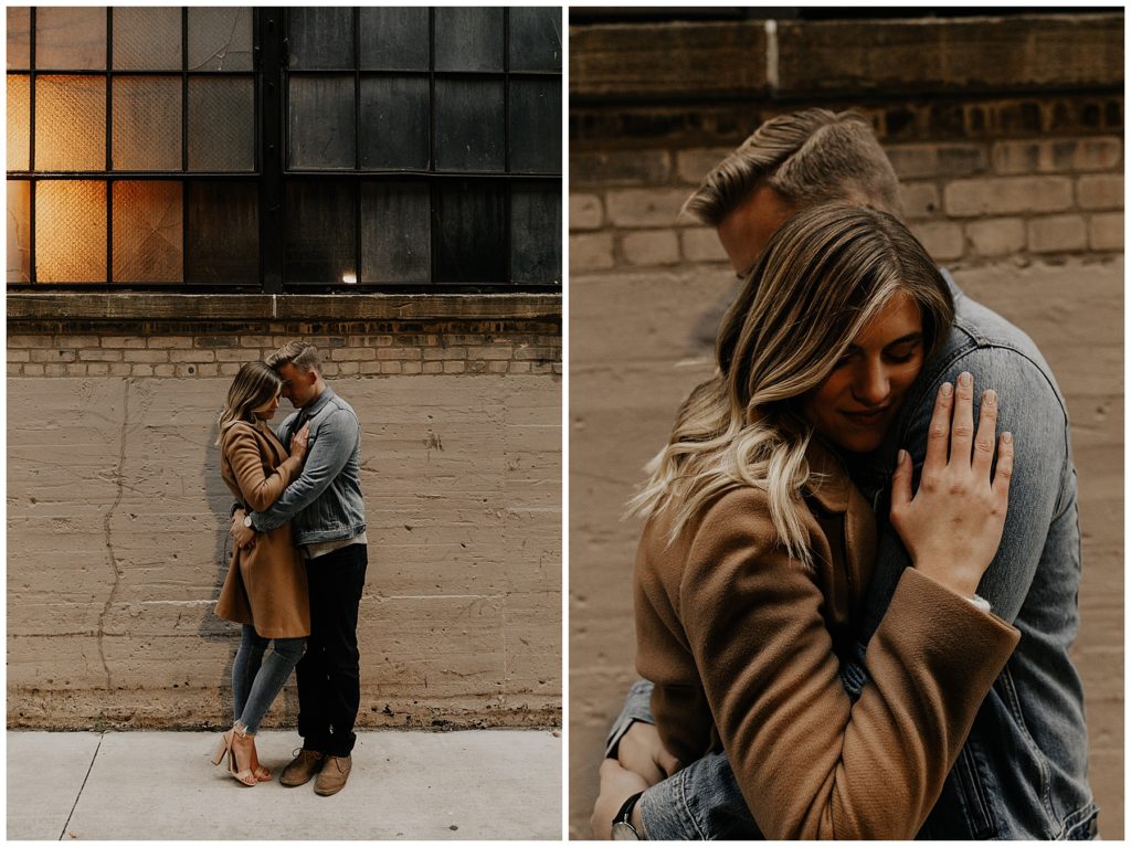 couples engagement session walking down the city streets on a fall day in Wisconsin