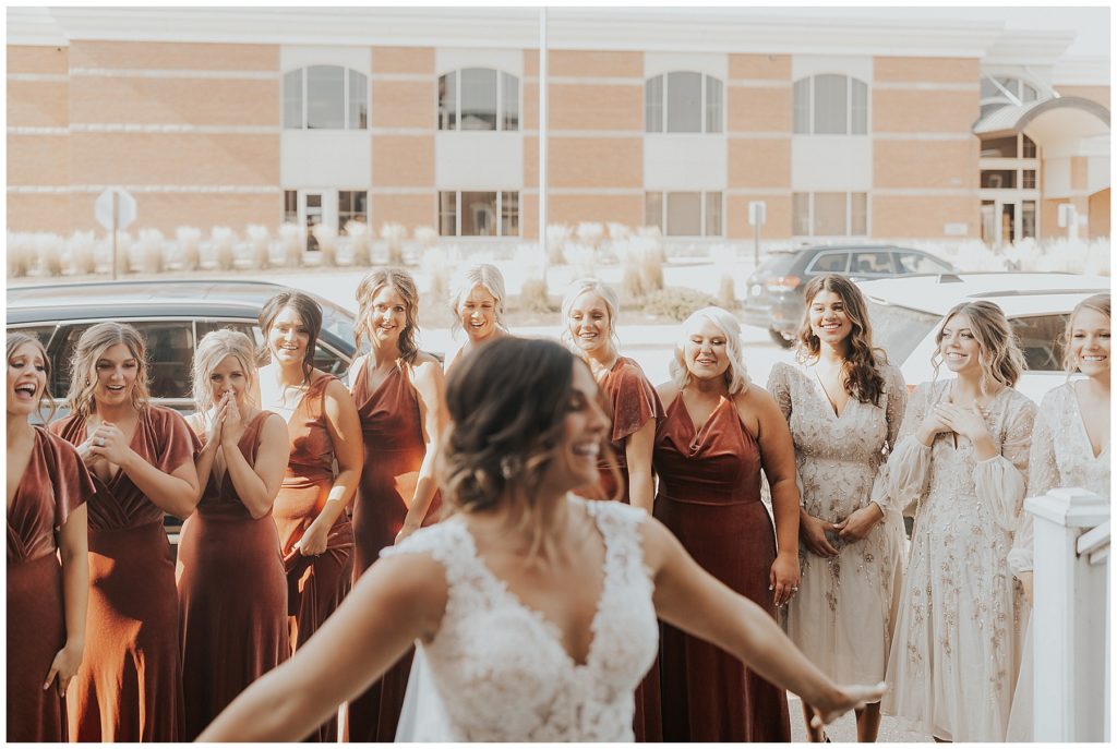 bridesmaids first look reaction to bride in wedding dress 