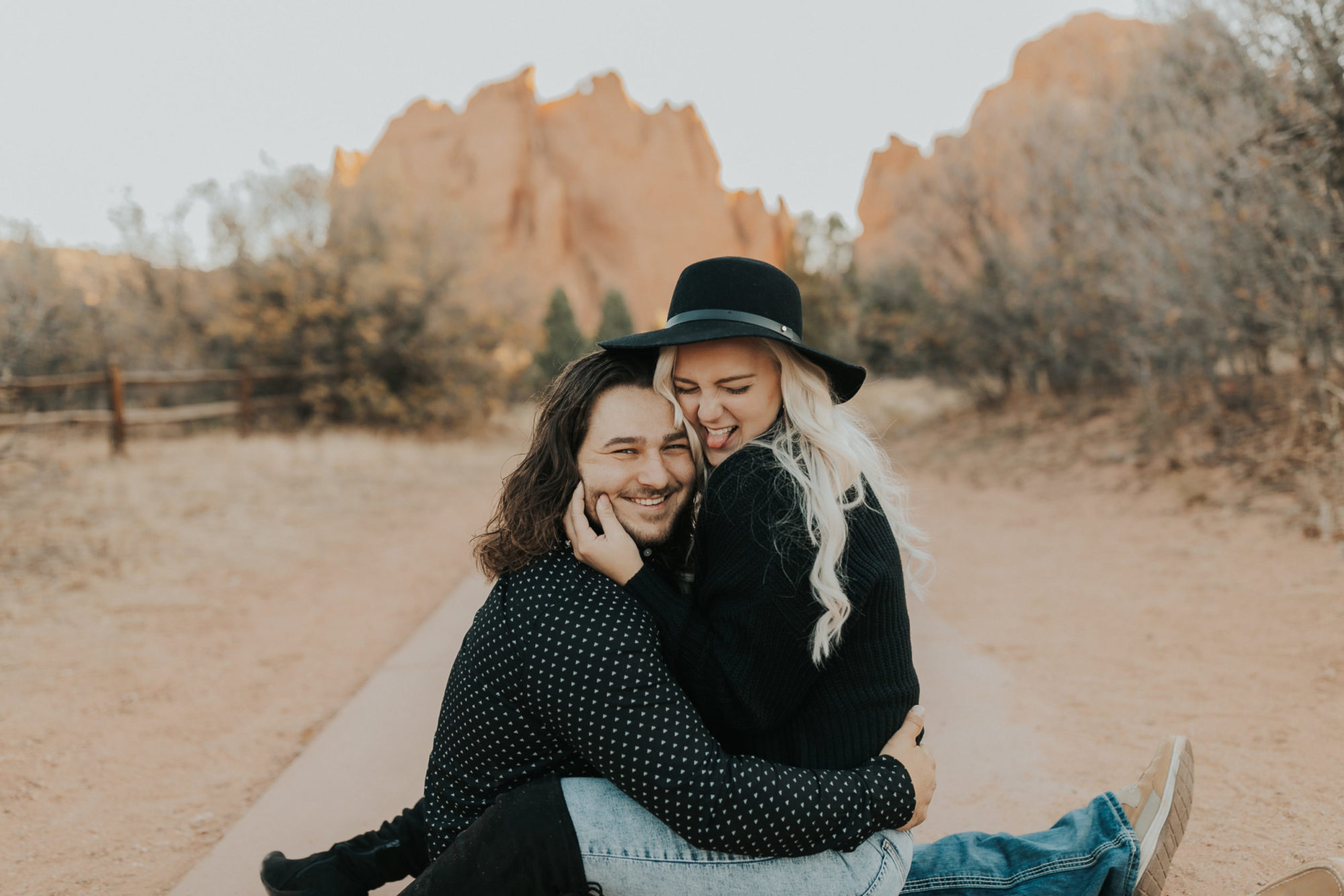 engaged couple taking photos in rib mountain state park, wearing black